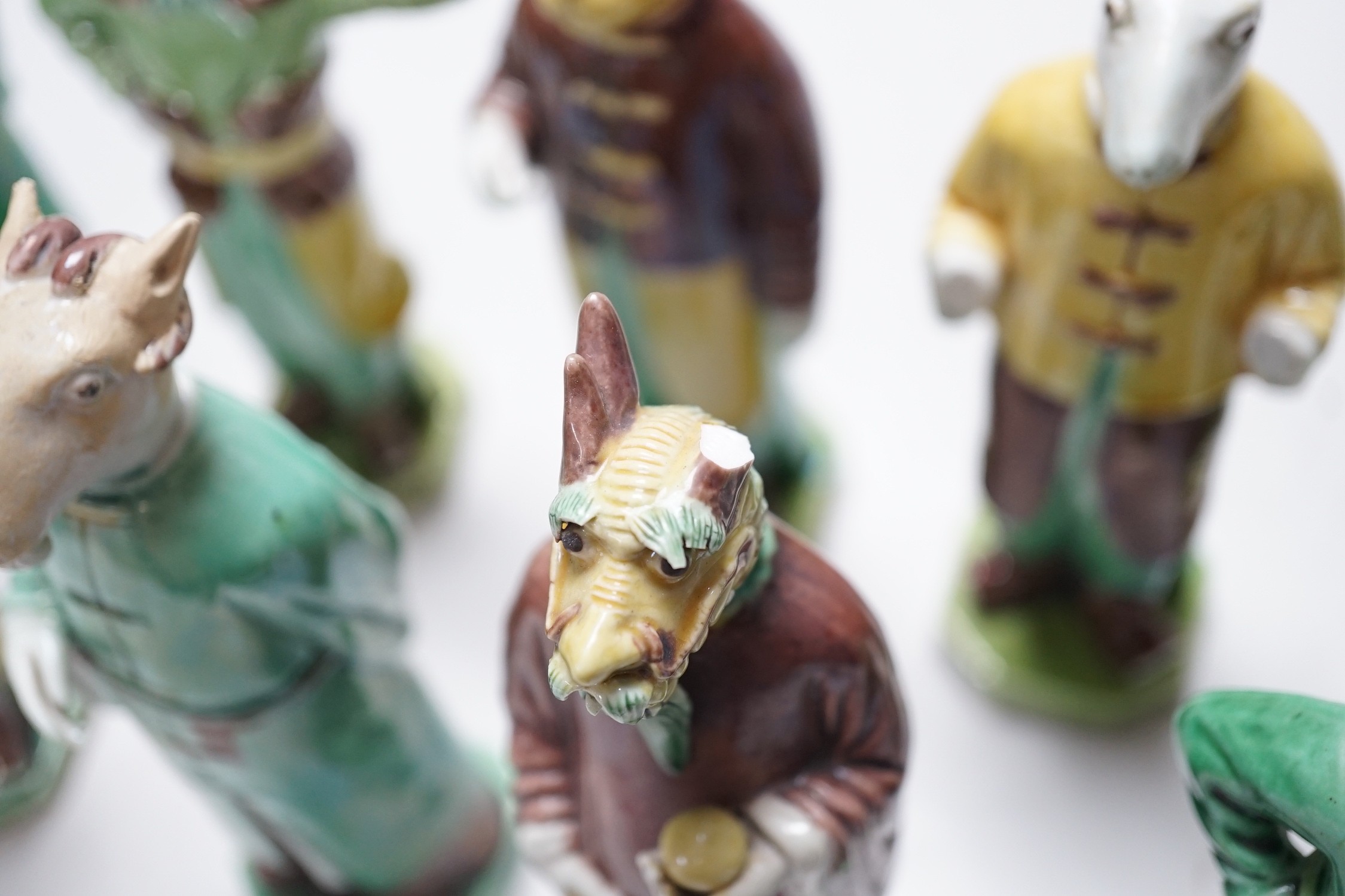 Ten Chinese Sancai glazed biscuit animal headed figures, tallest 17cm